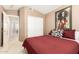 Bedroom featuring a red quilt and a closet with sliding doors at 780 W Morelos Ct, Chandler, AZ 85225