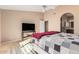 Bright bedroom has a cozy bed and a TV, with an ensuite bathroom for added privacy and functionality at 780 W Morelos Ct, Chandler, AZ 85225