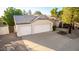 Aerial view showcasing a home with a three-car garage, tiled roof, and established desert landscaping at 780 W Morelos Ct, Chandler, AZ 85225