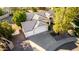 Aerial view of a home featuring a three-car garage, neutral exterior, tiled roof, and desert landscaping at 780 W Morelos Ct, Chandler, AZ 85225