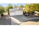 Aerial view of a home boasting a three-car garage, neutral color palette, well maintained landscaping and tiled roof at 780 W Morelos Ct, Chandler, AZ 85225