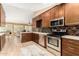Gourmet kitchen with stainless steel appliances, a large island, and an open layout to living area at 780 W Morelos Ct, Chandler, AZ 85225