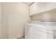 Laundry room with white cabinets and modern washer and dryer units at 780 W Morelos Ct, Chandler, AZ 85225