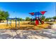 Colorful playground equipment with a shade canopy and soft landing surface for safety at 780 W Morelos Ct, Chandler, AZ 85225