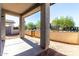 A covered back patio with a dirt backyard and a block wall at 9366 E Sequence Ave, Mesa, AZ 85212