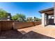 Backyard patio with block wall and landscaped neighborhood beyond at 9366 E Sequence Ave, Mesa, AZ 85212