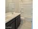 Bright bathroom with double sink vanity, dark cabinets, and a shower-tub combination, designed for everyday comfort at 9366 E Sequence Ave, Mesa, AZ 85212