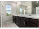 Bright bathroom features double sinks, dark wood cabinets, and tile flooring, exuding style and functionality at 9366 E Sequence Ave, Mesa, AZ 85212
