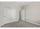 A carpeted bedroom with gray walls and a closet with sliding doors at 9366 E Sequence Ave, Mesa, AZ 85212