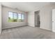 Bright bedroom with plush carpeting, large windows, and a walk-in closet at 9366 E Sequence Ave, Mesa, AZ 85212