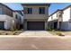 Home featuring a two car garage, neutral exterior, a long driveway, and low maintenance landscaping at 9366 E Sequence Ave, Mesa, AZ 85212