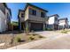 New home featuring a two-car garage, low maintenance landscaping, neutral exterior, and long driveway at 9366 E Sequence Ave, Mesa, AZ 85212