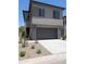Charming two-story home featuring a gray exterior, concrete driveway, and an attached two-car garage at 9366 E Sequence Ave, Mesa, AZ 85212