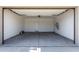 A large two-car garage with concrete floors at 9366 E Sequence Ave, Mesa, AZ 85212