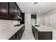 Elegant kitchen featuring granite counters, stainless appliances, and dark wood cabinetry at 9366 E Sequence Ave, Mesa, AZ 85212