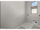A small, empty laundry room with tile floors and a window at 9366 E Sequence Ave, Mesa, AZ 85212