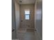 Functional laundry room with utility connections, a window for natural light, and durable tile flooring for easy cleaning at 9366 E Sequence Ave, Mesa, AZ 85212