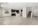 Open concept living room with wood look flooring, staircase, and updated kitchen at 9366 E Sequence Ave, Mesa, AZ 85212
