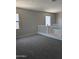 Cozy loft area with neutral carpet, bright windows, and a stylish white railing, offering a versatile living space at 9366 E Sequence Ave, Mesa, AZ 85212