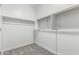 An empty walk-in closet with shelving and carpet, ready to be customized for ample storage at 9366 E Sequence Ave, Mesa, AZ 85212