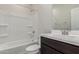 Bathroom with a combined shower and tub, dark wooden cabinets, and modern faucet fixture at 9416 E Sequence Ave, Mesa, AZ 85212