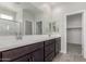 Modern bathroom features double sinks, a large mirror, and a shower with glass door at 9416 E Sequence Ave, Mesa, AZ 85212
