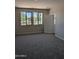 Cozy bedroom with neutral carpet, natural light, and a closet at 9416 E Sequence Ave, Mesa, AZ 85212