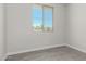 A bright bedroom featuring wood-look tile flooring and a window with neighborhood views at 9416 E Sequence Ave, Mesa, AZ 85212