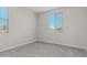 A cozy bedroom with neutral carpeting, a bright window, and modern paint color at 9416 E Sequence Ave, Mesa, AZ 85212