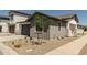 Charming home features low maintenance desert landscaping and a gray two-car garage at 9416 E Sequence Ave, Mesa, AZ 85212