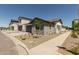 Charming home features low maintenance desert landscaping and a gray two-car garage at 9416 E Sequence Ave, Mesa, AZ 85212
