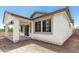 Exterior view of the home's covered patio with multiple windows at 9416 E Sequence Ave, Mesa, AZ 85212