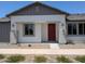 Charming single-story home featuring a stucco exterior, a red front door, and well-kept landscaping at 9416 E Sequence Ave, Mesa, AZ 85212