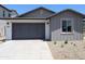 Attached two-car garage with gray door, concrete driveway and complementary gray painted siding at 9416 E Sequence Ave, Mesa, AZ 85212
