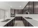 Contemporary kitchen boasts dark wood cabinetry, stainless steel appliances, and spacious countertops at 9416 E Sequence Ave, Mesa, AZ 85212