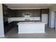 Modern kitchen featuring dark cabinetry, a large center island, and stainless steel appliances at 9416 E Sequence Ave, Mesa, AZ 85212
