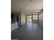 Open-concept living room featuring light colored walls and tiled floors with a large sliding glass door at 9416 E Sequence Ave, Mesa, AZ 85212