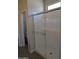 Bathroom shower with glass doors and a white tiled surround at 9416 E Sequence Ave, Mesa, AZ 85212