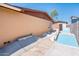 Backyard featuring a concrete ramp and a painted block wall under a clear blue sky at 11030 N 47Th Ave, Glendale, AZ 85304