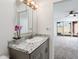 Bathroom featuring granite countertops, mirror, and open access to a bedroom at 11030 N 47Th Ave, Glendale, AZ 85304