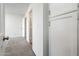 Bright hallway featuring storage cabinets and access to carpeted bedroom at 11030 N 47Th Ave, Glendale, AZ 85304