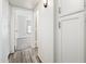 Hallway featuring wood-look floors and access to carpeted bedroom at 11030 N 47Th Ave, Glendale, AZ 85304