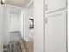 Hallway featuring wood-look floors and access to a bright bedroom at 11030 N 47Th Ave, Glendale, AZ 85304