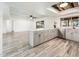 Bright open floor plan with wood-look floors and a modern kitchen featuring gray cabinets at 11030 N 47Th Ave, Glendale, AZ 85304