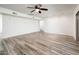 A bright living room with wood-look tile flooring, recessed lighting, and a ceiling fan at 11030 N 47Th Ave, Glendale, AZ 85304