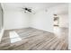 Spacious living room with wood-look tile flooring, recessed lighting, and neutral decor at 11030 N 47Th Ave, Glendale, AZ 85304