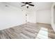 A bright living room with wood-look tile flooring and a ceiling fan at 11030 N 47Th Ave, Glendale, AZ 85304