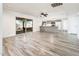 Open-concept living room featuring wood floors, a ceiling fan, and sliding glass doors to backyard at 11030 N 47Th Ave, Glendale, AZ 85304