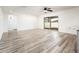 Open living room featuring wood-look tile flooring and sliding glass doors to the outdoors at 11030 N 47Th Ave, Glendale, AZ 85304