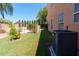 Well-maintained backyard with lush green lawn, pool area, and an AC unit, perfect for relaxing at 111 N Soho Pl, Chandler, AZ 85225
